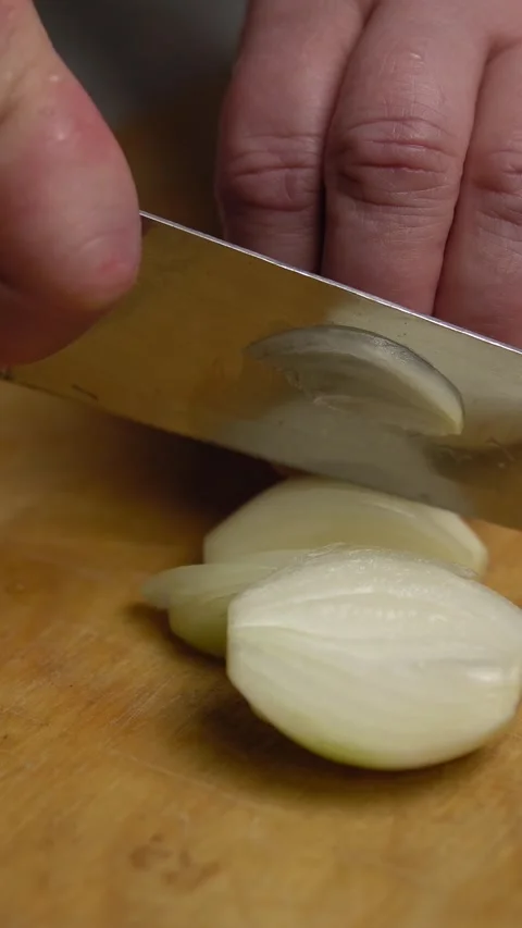 Hands with a knife cut onions, vertical video Stock Footage 246835201