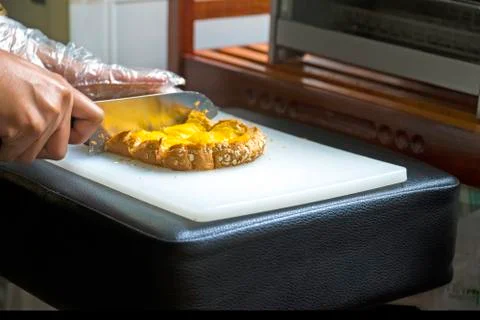 Hands knife cutting of sliced bread bakery Stock Photos