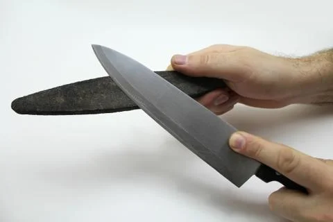 Hands with knife on white Stock Photos