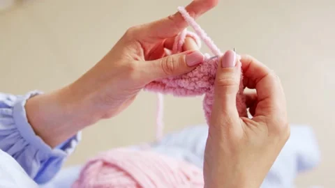 Hands knit with knitting needles and woolen fluffy pink threads Stock Footage 201850093