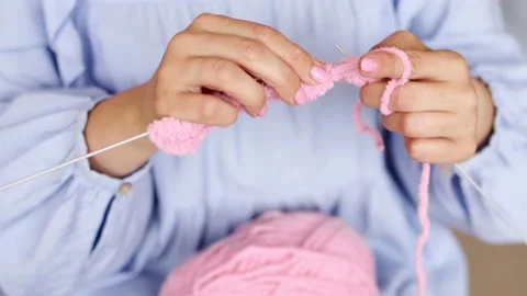 Hands knit with knitting needles and woolen fluffy pink threads Stock Footage 201850108