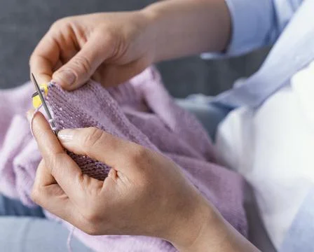 Hands knitting on couch close up Stock Photos