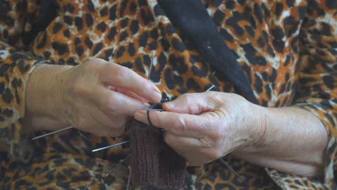 Hands Knitting with Needles in Patterned Fabric 스톡 동영상 308617615