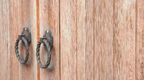 Hands knock on old-fashioned ancient wooden gate or door Stock Footage 50856344