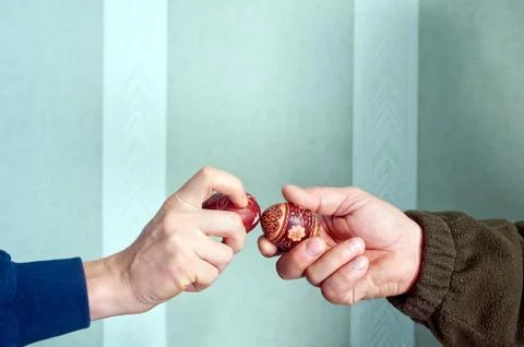 Hands knocking easter eggs Stock Photos