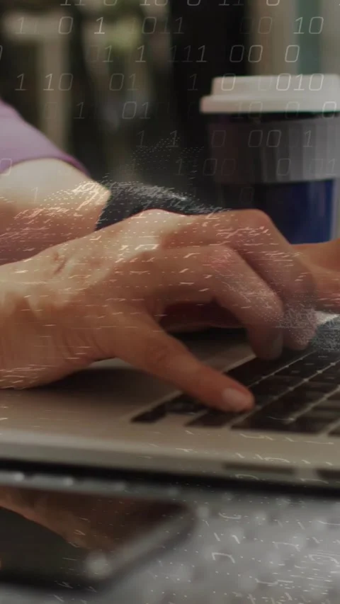 Hands landing on keys, typing while binary overlay appearing over laptop, Stock Footage 331638686