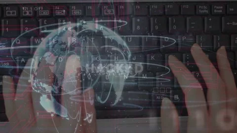 Hands landing on keys typing while globe appearing rings orbiting HACKED Stock Footage 333803551