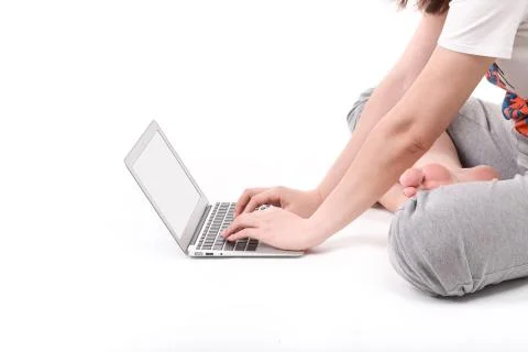 Hands on the laptop computer isolated on white. Stock Photos