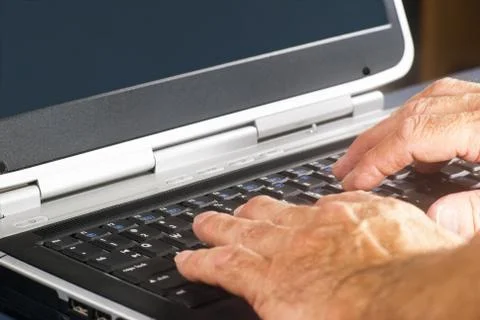 Hands On A Laptop Computer Keyboard Stock Photos