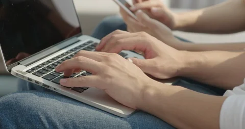 Hands with laptop, hands on smartphone, close-up Stock Footage 100942078