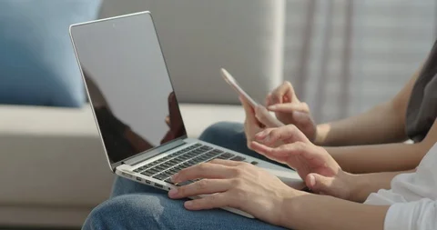 Hands with laptop, hands on smartphone, close-up Stock Footage 100942084