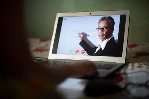 Hands on laptop keypad while attending online classes in home isolation due t Stock Photos