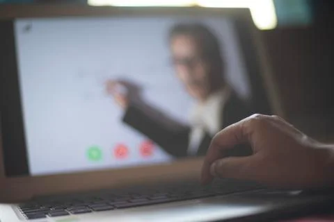 Hands on laptop keypad while attending online classes in home isolation due t Stock Photos