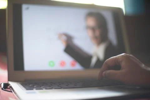 Hands on laptop keypad while attending online classes in home isolation due t Stock Photos