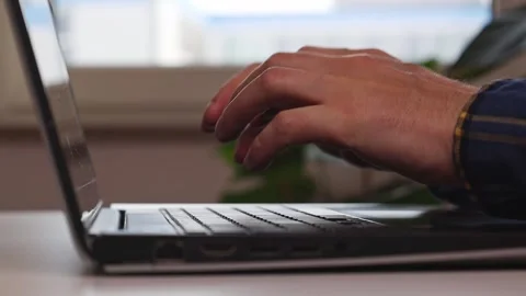 Hands at the laptop at the table, doing hand gymnastics Video stock 244599156