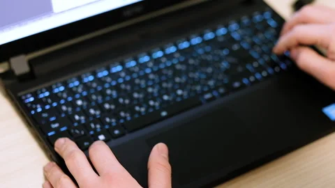 Hands at the laptop at work in disfocus Stock Footage 237080596