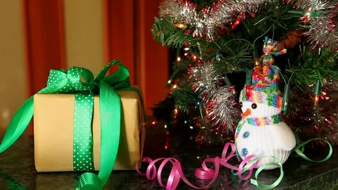 Hands lay down gift box near christmas tree Stock Footage 81829645