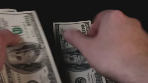 Hands lay out 100 dollar bills on the table. The concept of career growth, finan Stock Footage 221647404