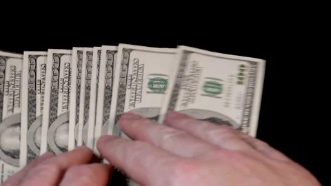 Hands lay out 100 dollar bills on the table. The concept of career growth, finan Stock Footage 221647423