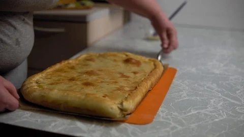 Hands lay out potato pie Stock Footage 120296084