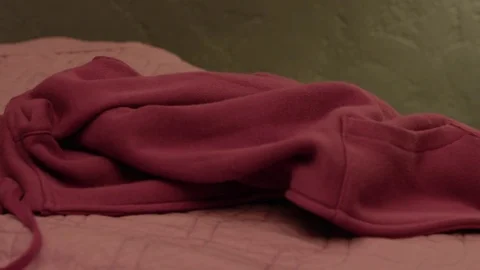 Hands lay pink jacket on bed, closeup Stock Footage 82812292