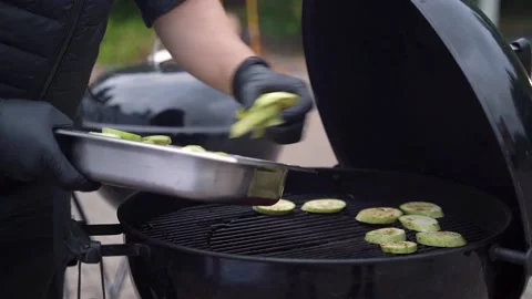 Hands lay zucchini on a grill Video stock 218612843
