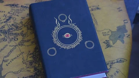 Hands leafing through The Lord of the Rings thick English book Stock Footage 153980687
