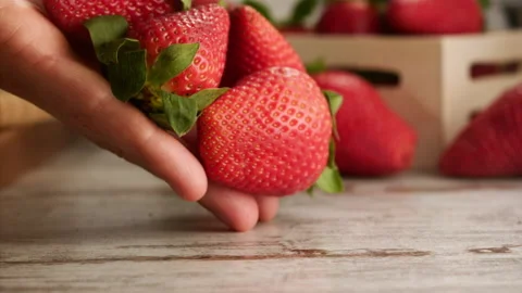Hands leave strawberries on table in slow motion Stock Footage 156202947