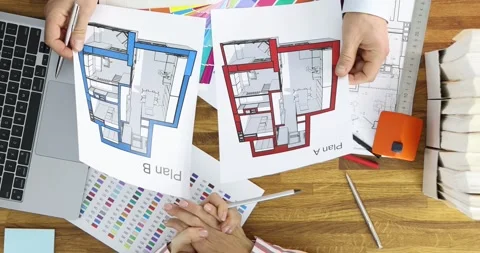 Hands lift floor plans creating architectural comparison scene Stock Footage 312937916