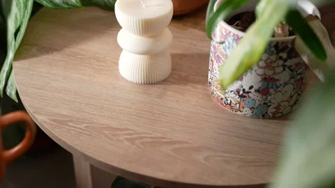 Hands Lifting an Orange Mug with a Tea Bag from a Nightstand Stock Footage 302820520