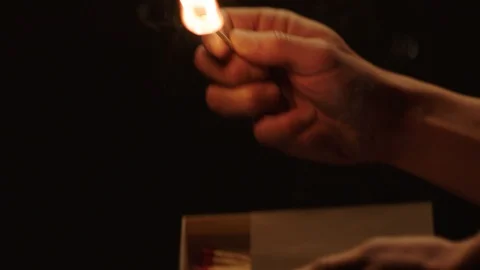 Hands light a match Stock Footage 103368203