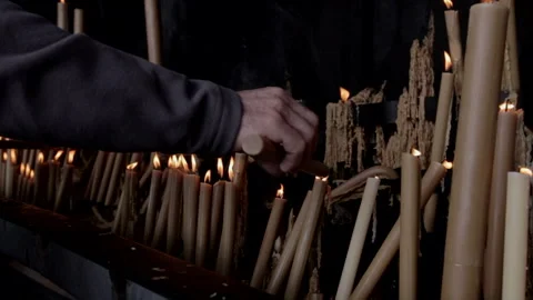 Hands lighting candles in a sacred space Stock Footage 324966470