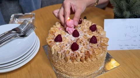 Hands Lighting Pink Bear Candle On Birthday Cake Stock Footage 340848566