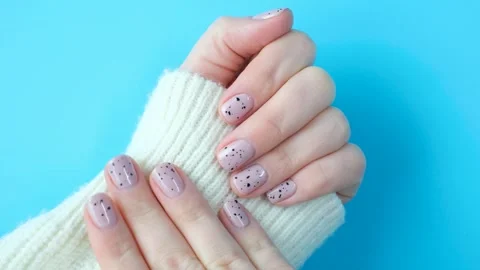 Hands with lilac manicure on blue background close-up. Stock Footage 263080863