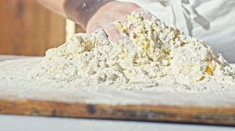 Hands of little baker mixed eggs with flour to make dough for bread Stock Footage