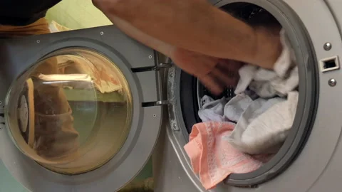 Hands load things into the washing machine. Stock Footage 161301729