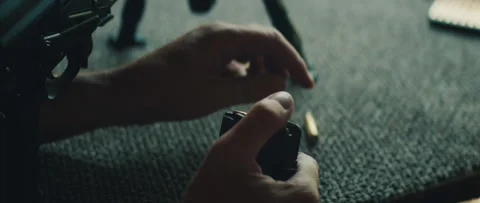 Hands loading bullet into magazine during shooting session on range outdoors Stock Footage 313734158