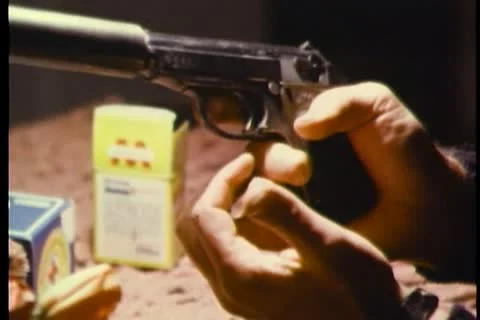 Hands loading gun with silencer Stock Footage 11350823