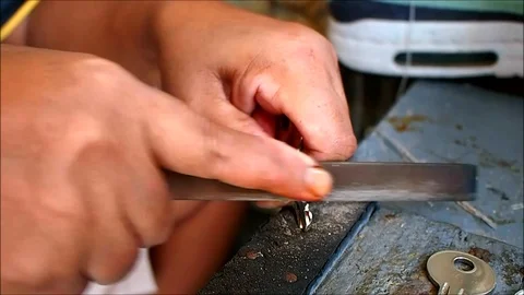 Hands of a locksmith duplicating a key Video stock 93341330
