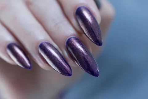 Hands with long nails and black purple manicure Foto stock