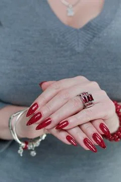 Hands with long nails and a bright red and black manicure Photos