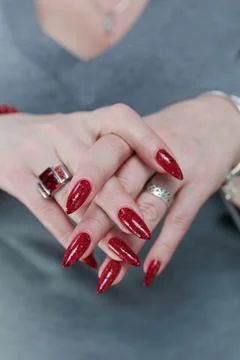 Hands with long nails and a bright red and black manicure Stock Photos