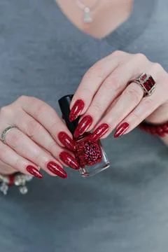 Hands with long nails and a bright red and black manicure Stockfoto's
