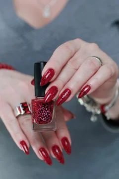 Hands with long nails and a bright red and black manicure Фото