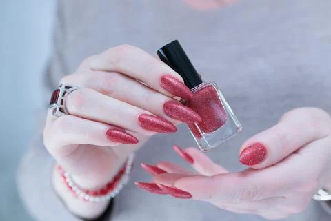 Hands with long nails and dark red nail polish Stock Photos