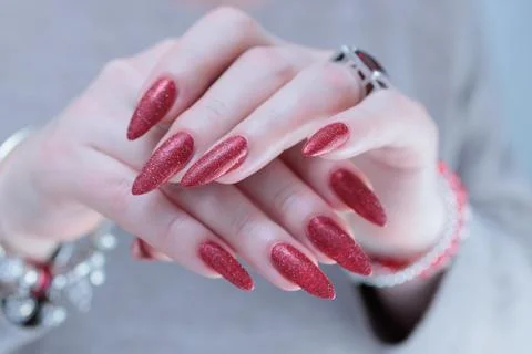 Hands with long nails and dark red nail polish Stock Photos
