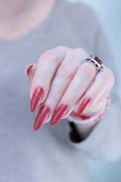 Hands with long nails and dark red nail polish 스톡 사진