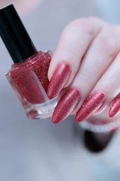 Hands with long nails and dark red nail polish Stock Photos