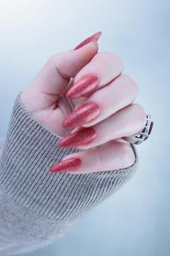 Hands with long nails and dark red nail polish Stock Photos