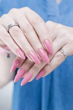 Hands with long nails and light pink manicure Photos